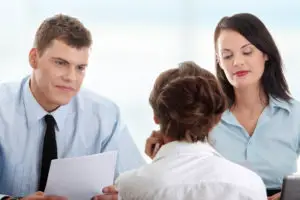 a typical setting in an interview in a smaller company. Two interviewers, man and woman, and one job candidate 
